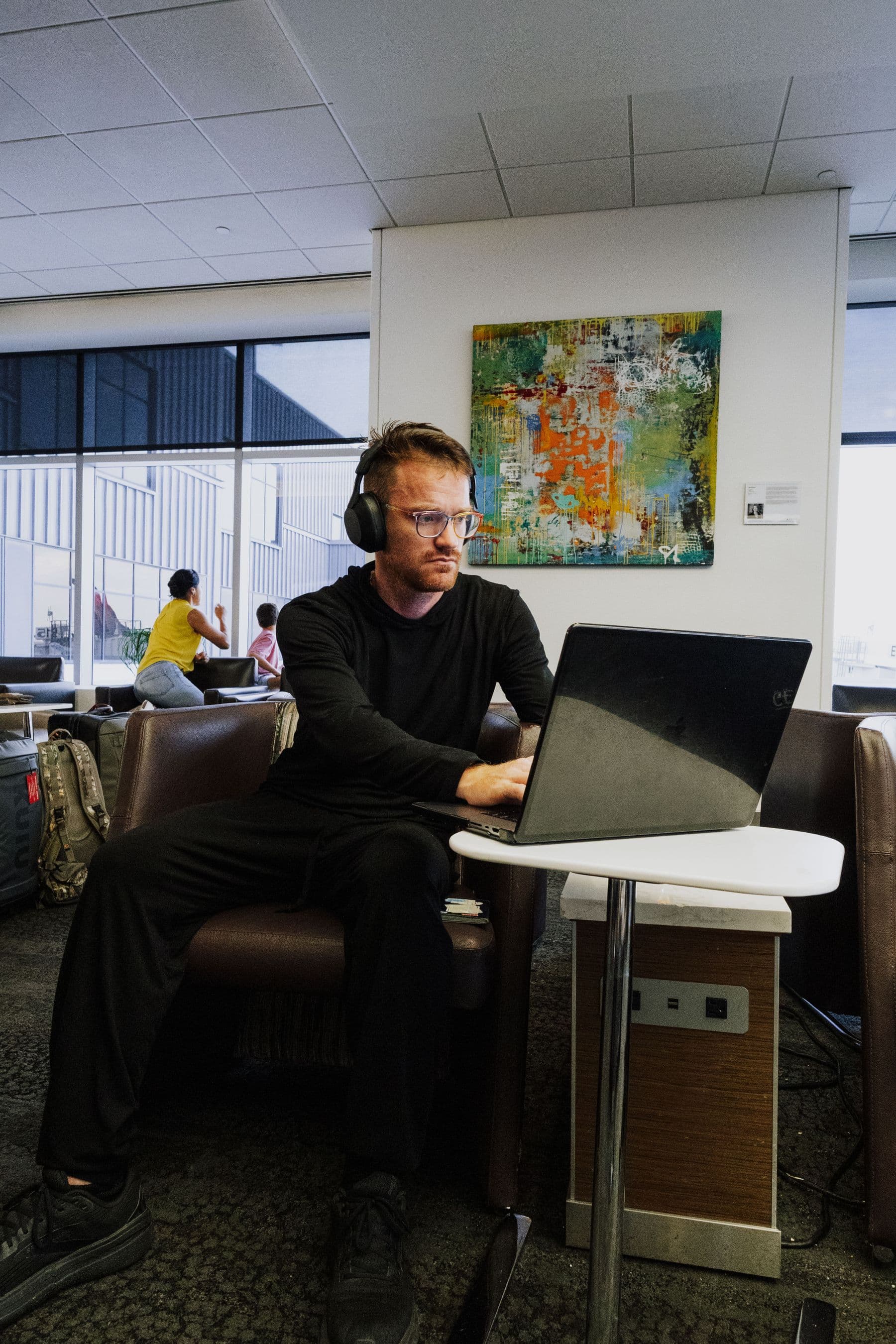 Business traveller using connected technology in an airport lounge